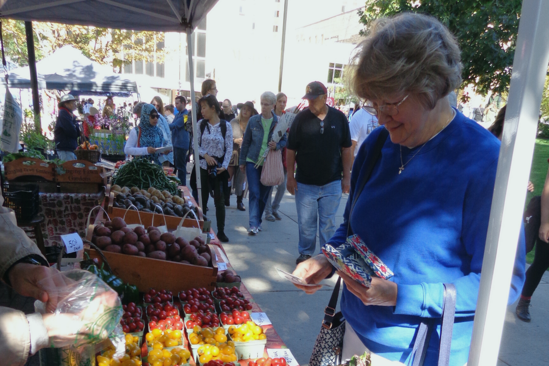Alice shopping at the Dane County Farmers Market